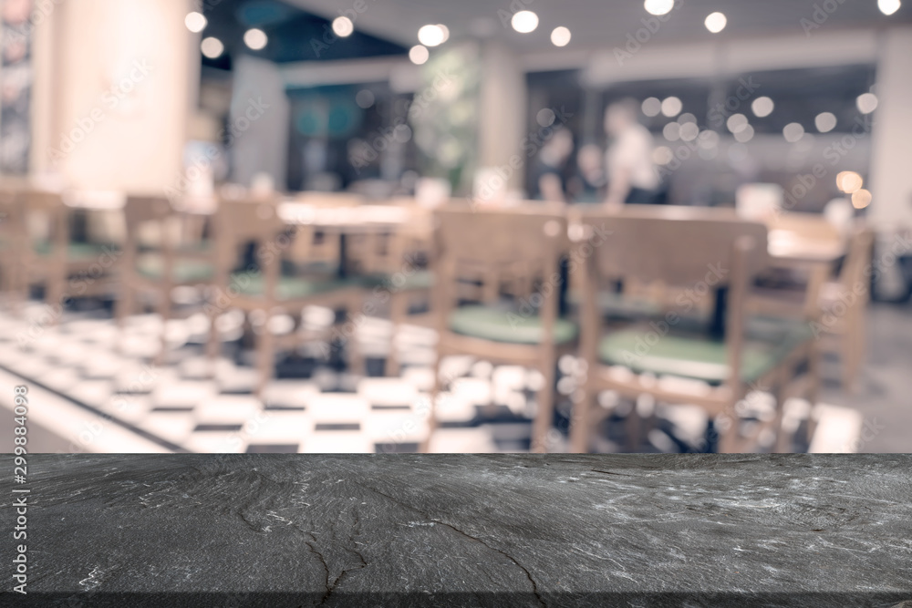 top black marble table with restaurant blur background