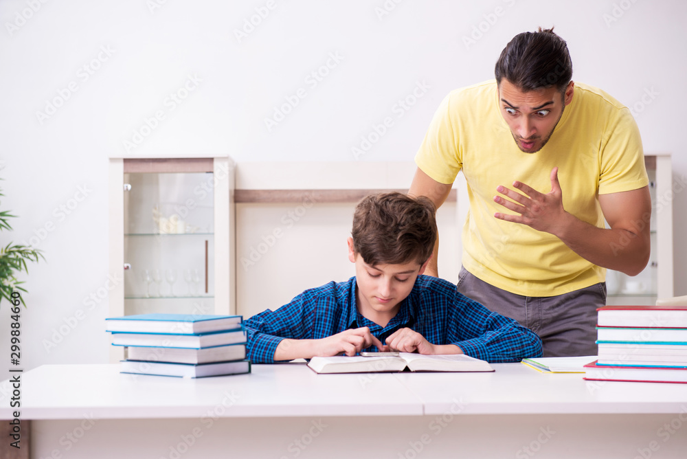 Father helping his son to prepare for school Father helping his son to prepare for school