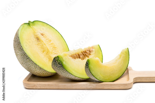 green melon on wooden tray isolated on white background