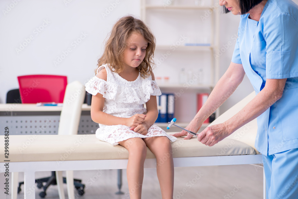 Fototapeta premium Little girl visiting old female doctor