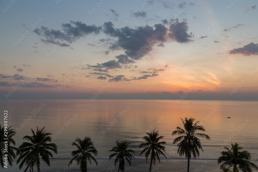 Tranquil sunrise in Hua Hin beach with coconut trees, Thailand Tranquil sunrise in Hua Hin beach with coconut trees, Thailand