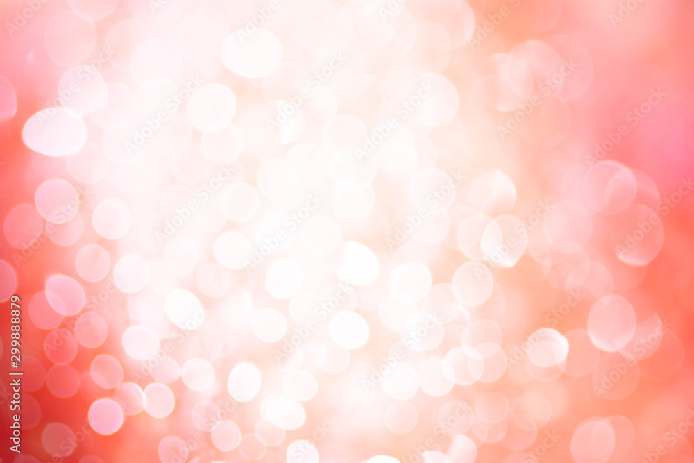 Bokeh blurry image on orange, white and pink background.