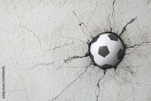 Sport soccer ball coming in cracked wall with grunge texture. photo