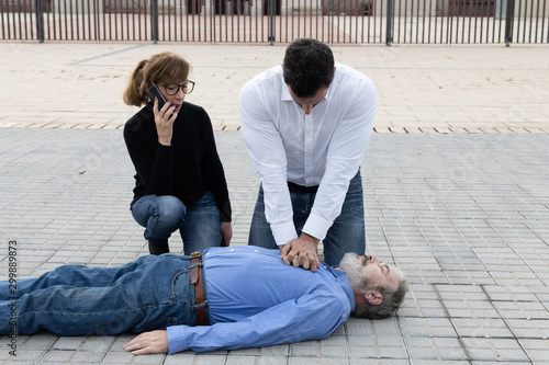 CPR. Emergency call phase and start of thoracic compressions photo