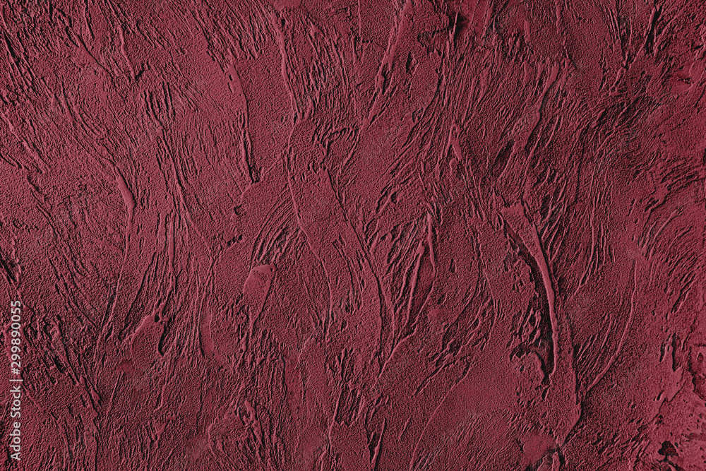 Dark red colored low contrast Concrete textured background with roughness and irregularities to your design or product. Color trend concept.