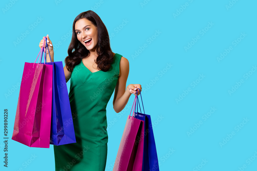 Fashion Beauty photos of a Shopping Girl. Photo of nice Charming Girl attractive joyful girl having just ended up Shopping and being overjoyed and cheerful. isolated. Blue Background 