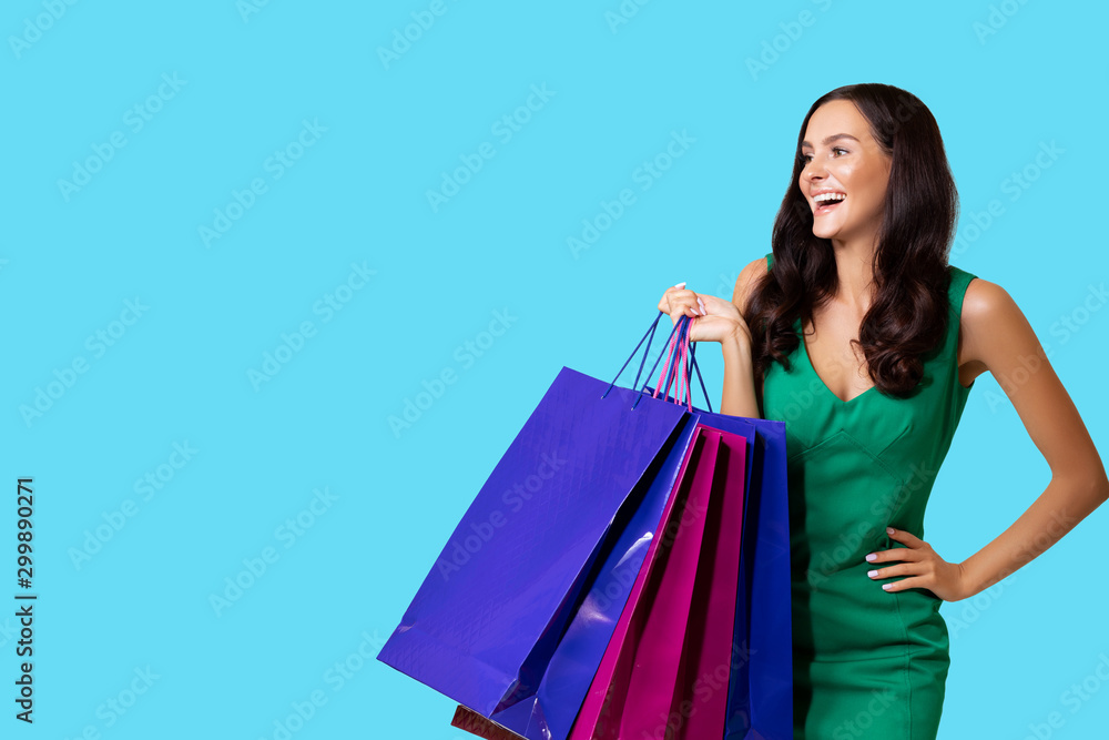 Fashion Beauty photos of a Shopping Girl. Photo of nice Charming Girl attractive joyful girl having just ended up Shopping and being overjoyed and cheerful. isolated. Blue Background