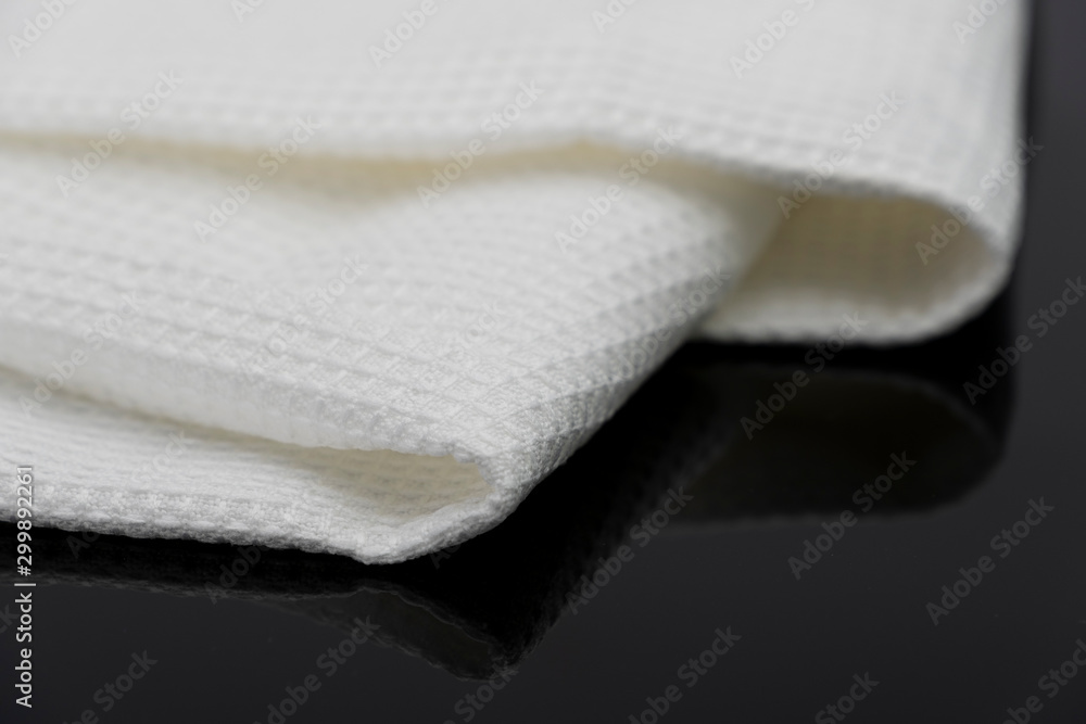 Macro shot texture of folded white towel kitchen fabric isolated on black background Macro shot texture of folded white towel kitchen fabric isolated on black background