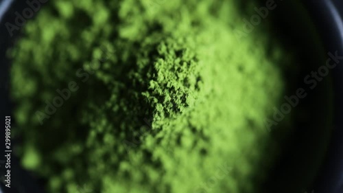 Powdered hill green tea in the bowl at dark background