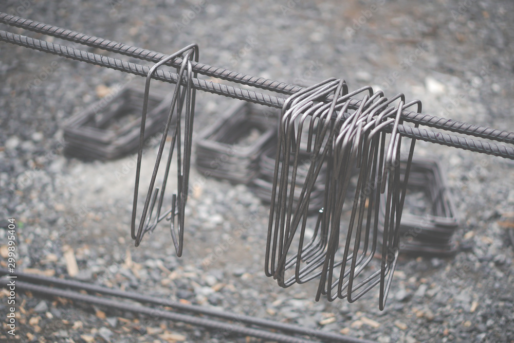 Metal chain links and rebar hanging on steel line. Metal chain links and rebar hanging on steel line.