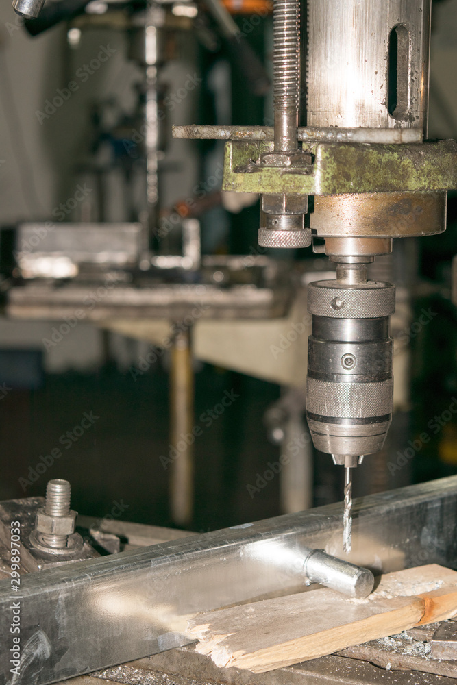 drill bit drills a hole in the metal part drill bit drills a hole in the metal part
