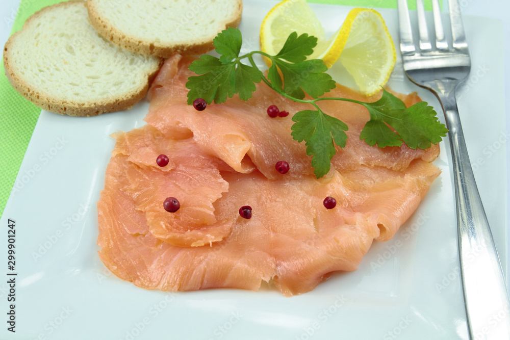 plate of smoked salmon sliced on a table plate of smoked salmon sliced on a table