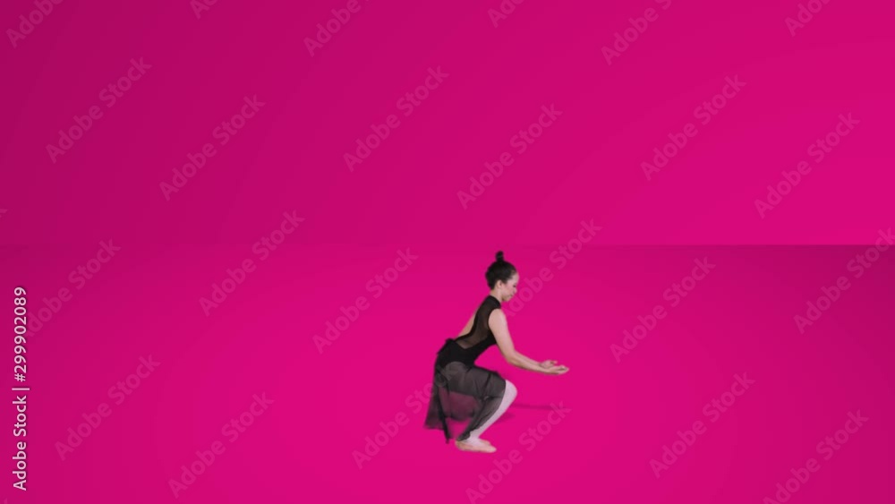 Slow motion of ballet dancer jumping in the studio with pink background Slow motion of ballet dancer jumping in the studio with pink background
