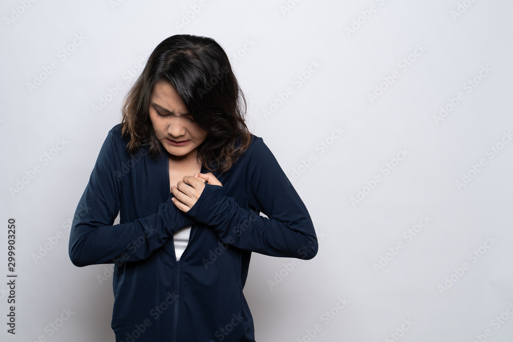 Woman has chest pain isolated over white background Woman has chest pain isolated over white background