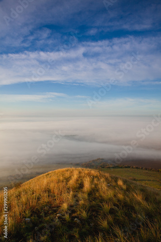 View from Rana hill.Misty morning in Central Bohemian Highlands, Czech Republic. Central Bohemian Uplands is a mountain range located in northern Bohemia. The range is about 80 km long