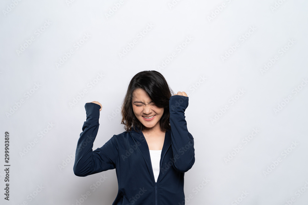 Portrait of a healthy woman make winning gesture isolated over white background Portrait of a healthy woman make winning gesture isolated over white background
