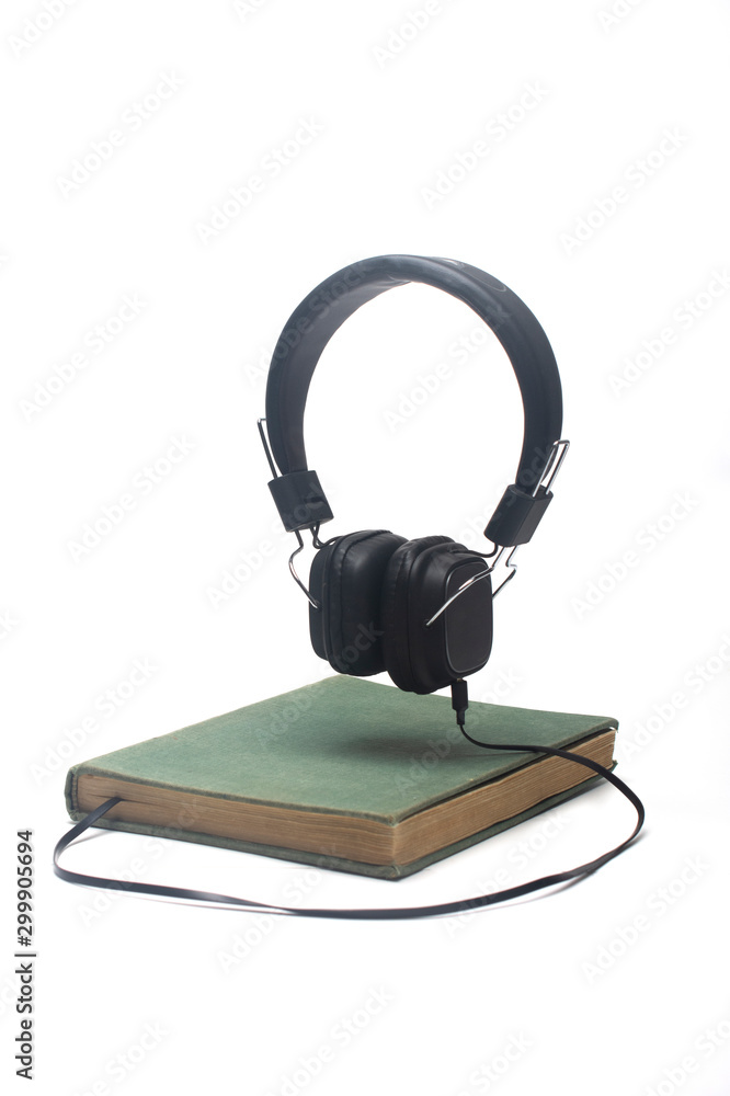book with headphones. Audiobook concept book with headphones. Audiobook concept