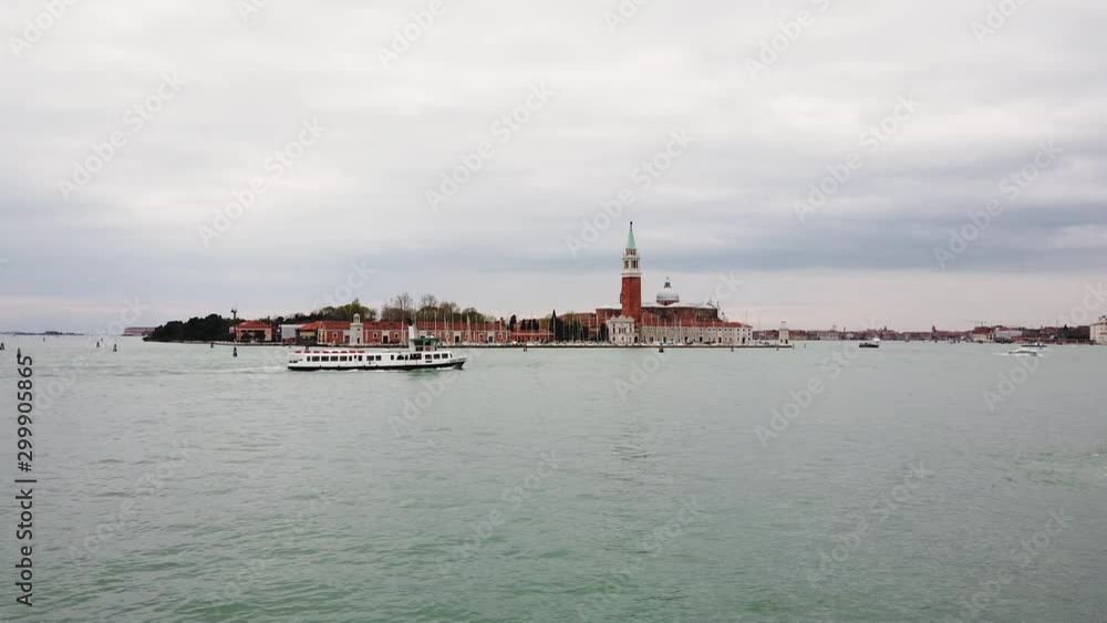 Venice, Italy - March 29, 2019 - 4K video of boat passing on Canal Grande with San Giorgio Maggiore church in the distance shot in the beautiful city of Venice, Italy Venice, Italy - March 29, 2019 - 4K video of boat passing on Canal Grande with San Giorgio Maggiore church in the distance shot in the beautiful city of Venice, Italy