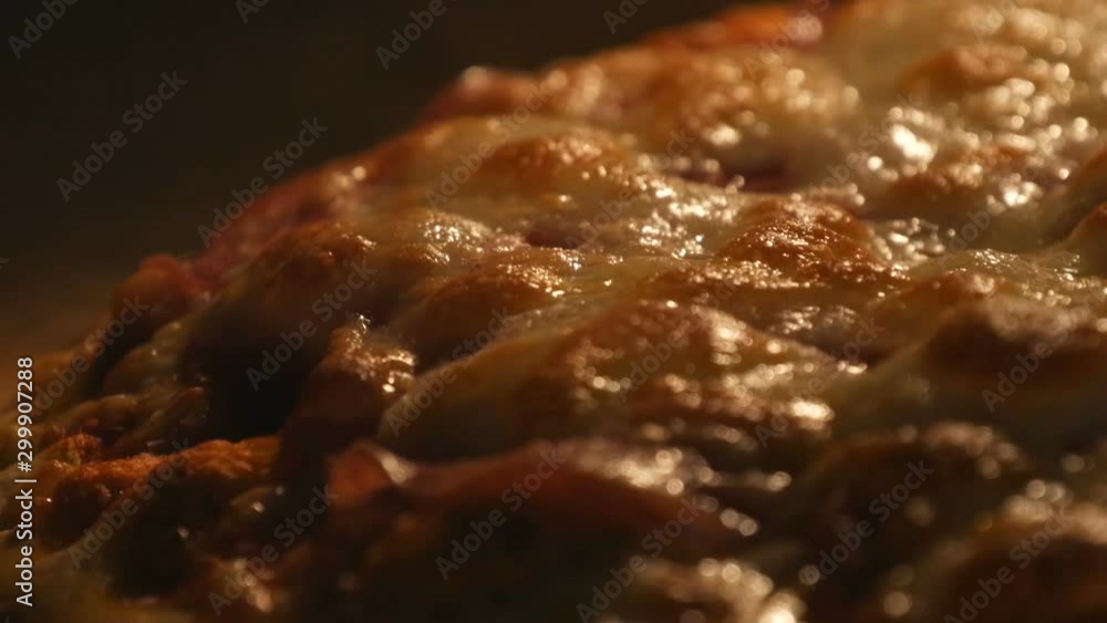Cheese on pizza melts from oven heat close up view Cheese on pizza melts from oven heat close up view