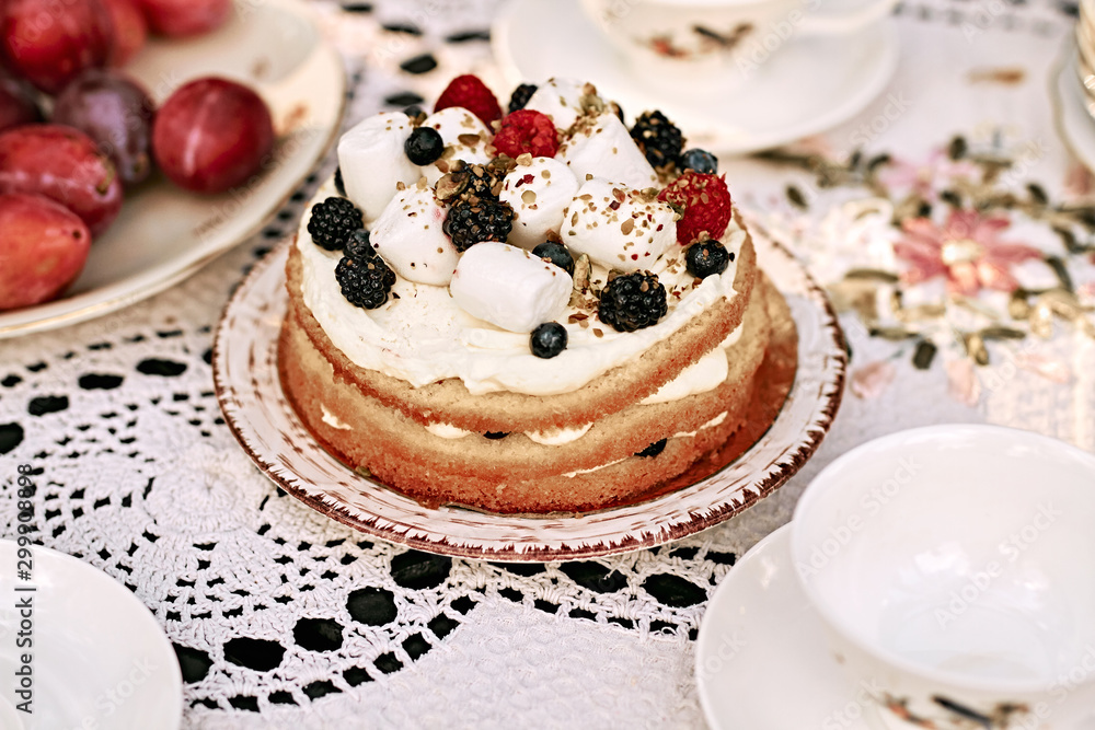 Homemade festive berry cake with souffle decorated with raspberries, blueberries, blackberries Homemade festive berry cake with souffle decorated with raspberries, blueberries, blackberries