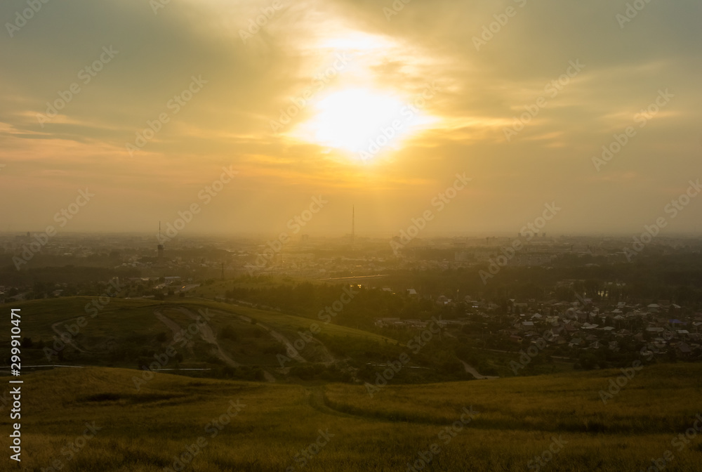 Khakassiya region, travel, landscape and nature of Russia. Yellow golden orange dramatic dawn at dawn or dusk over endless fields, hills, meadows. The sun rises in the morning above the horizon