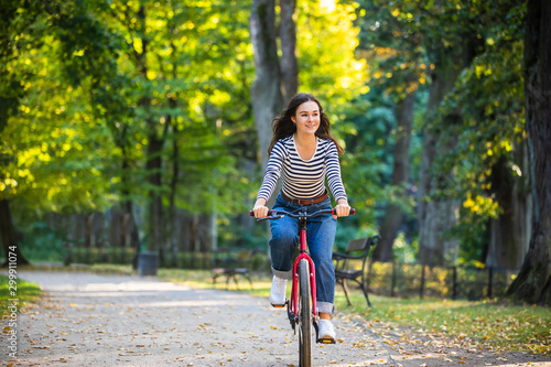 Urban biking - woman riding bike in city park © Jacek Chabraszewski