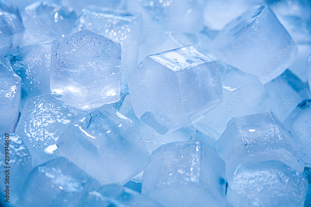 Macro shot of ice cubes from clear water that melt in slow motion on a white background. Concept: pure mountain spring water, ice, cocktails, fresh and frozen foods.