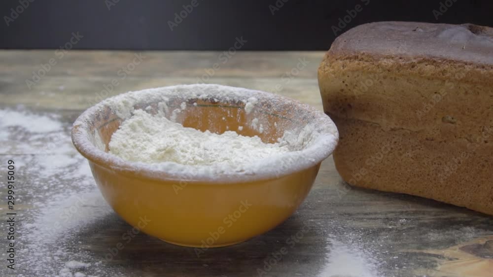 Slow motion of falling eggs into flour stock. Footage food. Egg dropping into flour, slow motion. Yolk Falls Into the Flour. Food Blog, Flour Products. Bakery products. Preparation of the dough Slow motion of falling eggs into flour stock. Footage food. Egg dropping into flour, slow motion. Yolk Falls Into the Flour. Food Blog, Flour Products. Bakery products. Preparation of the dough