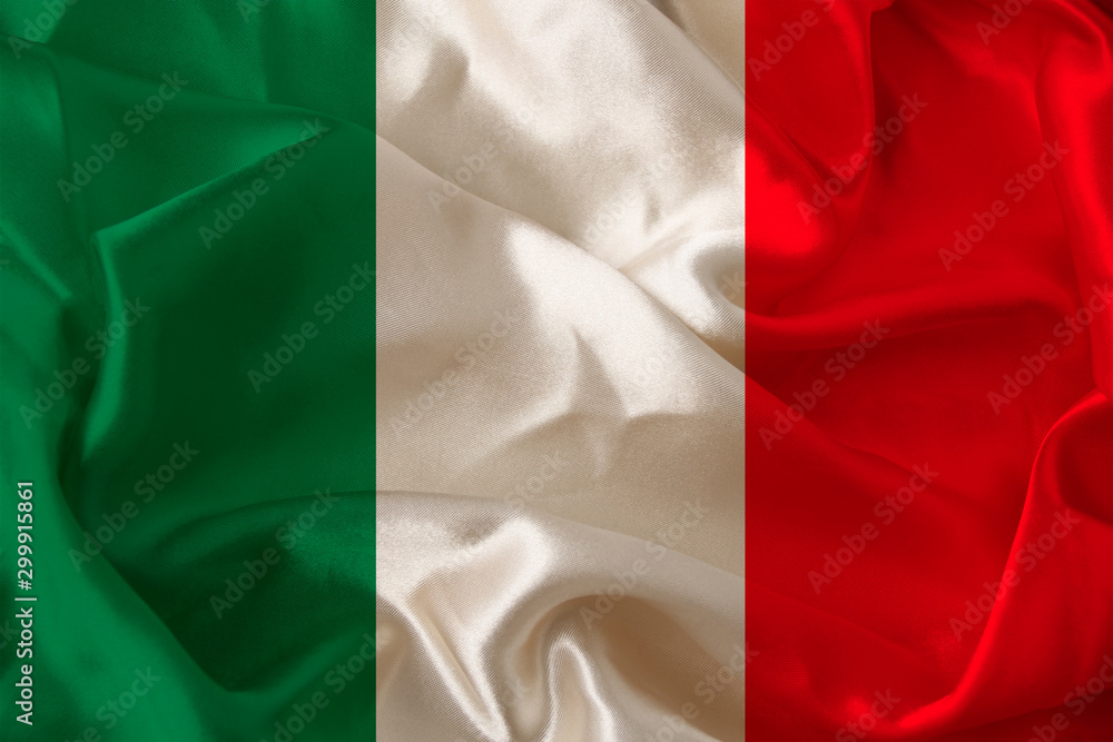 beautiful colored photograph of the beautiful colored national flag of the modern state of Italy on textured fabric, concept of tourism, emigration, economics and politics, closeup