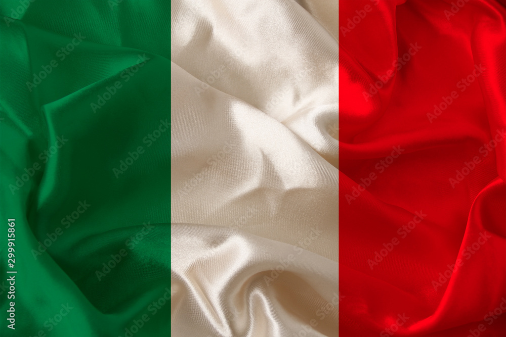 Obraz premium beautiful colored photograph of the beautiful colored national flag of the modern state of Italy on textured fabric, concept of tourism, emigration, economics and politics, closeup