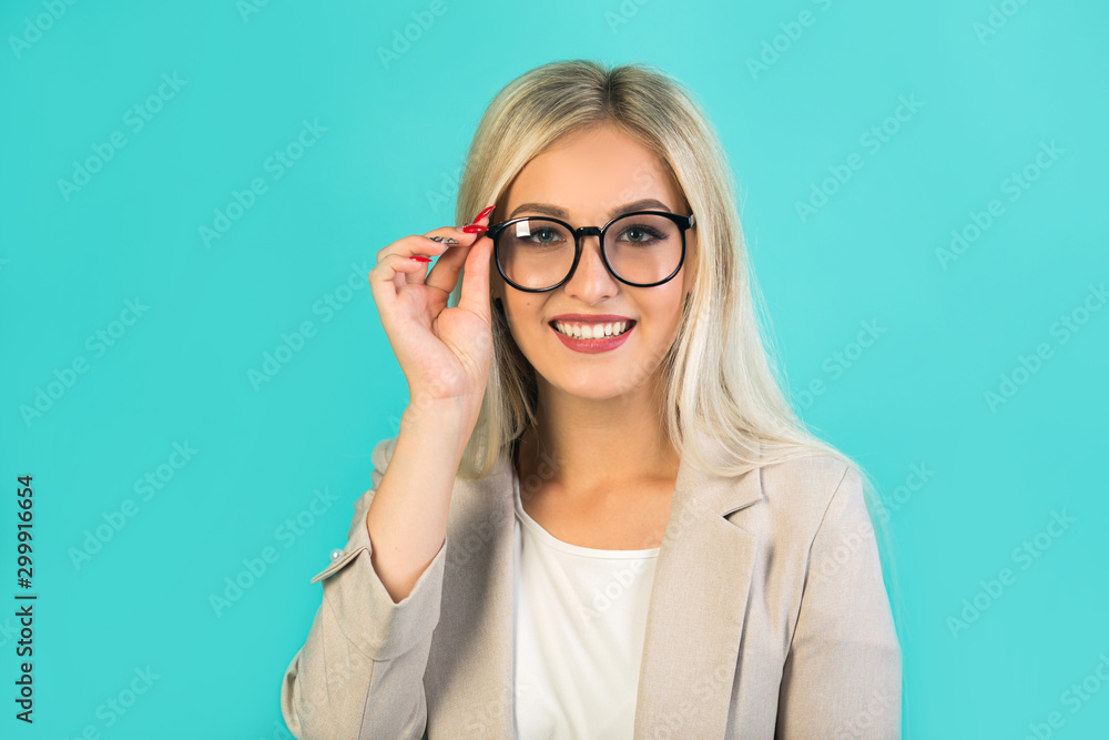 beautiful young woman in suit with glasses on a blue background