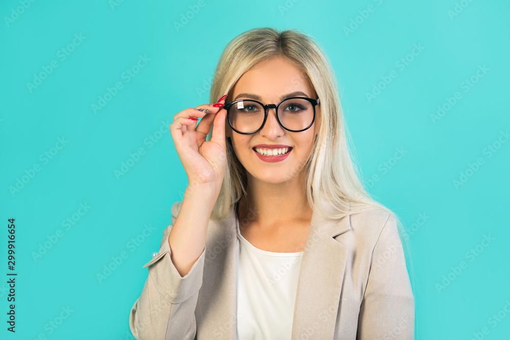 Fototapeta premium beautiful young woman in suit with glasses on a blue background