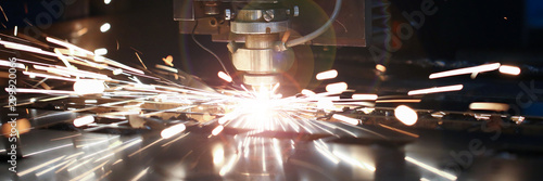 Laser metall cut cnc machine. Fly fire sparks background. photo