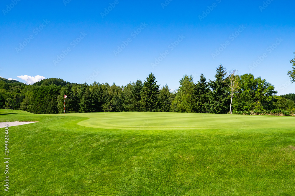 View of Golf Course with beautiful putting green. Golf course with a rich green turf beautiful scenery.