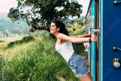 Travel by train. The girl travels by train to beautiful places. Beautiful girl traveling by train among mountains. Travel the world. Trains Sri Lanka. Railway transport. Railway. Transport Asia photo