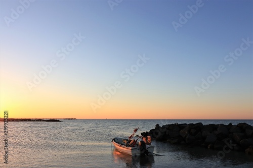 fishing boat and seabridge at sunset