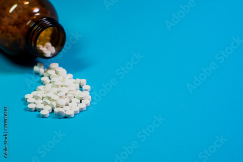 pills and bottle on blue background