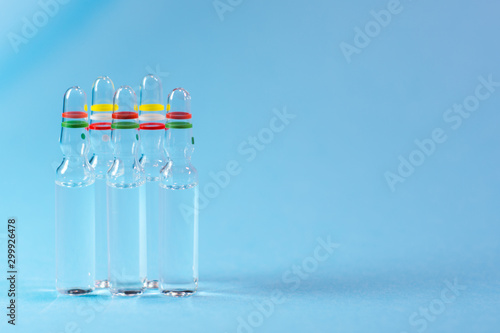 Medical ampules on blue background
