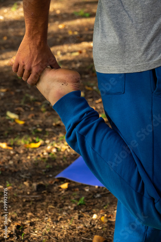  man in yoga posture holding one foot in balance