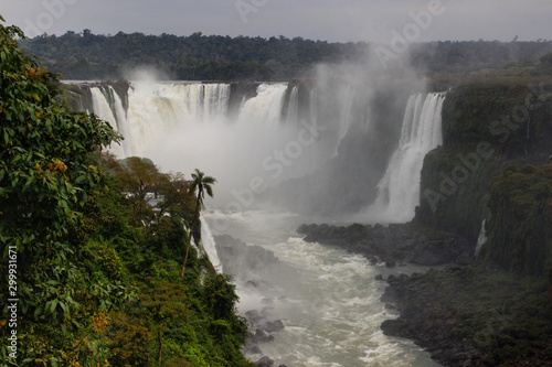 The main attraction of Brazil and Argentina is the famous Iguazu Falls among the lush green jungle. Huge streams of water fall to the ground. UNESCO World Heritage. Picture from paradise.