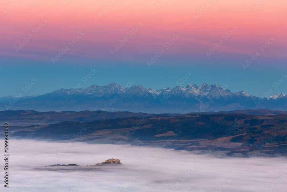 Spiski Castle with Tatra Mountains in foggy sunrise Slovakia landscape