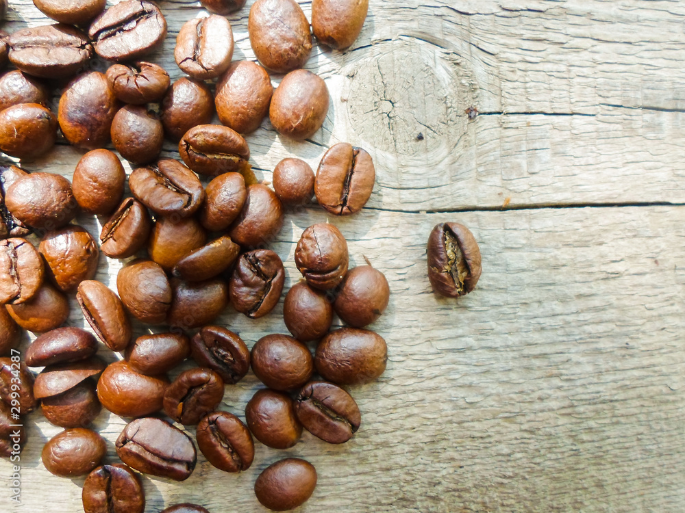 large grains of coffee on a wooden table. place for text large grains of coffee on a wooden table. place for text