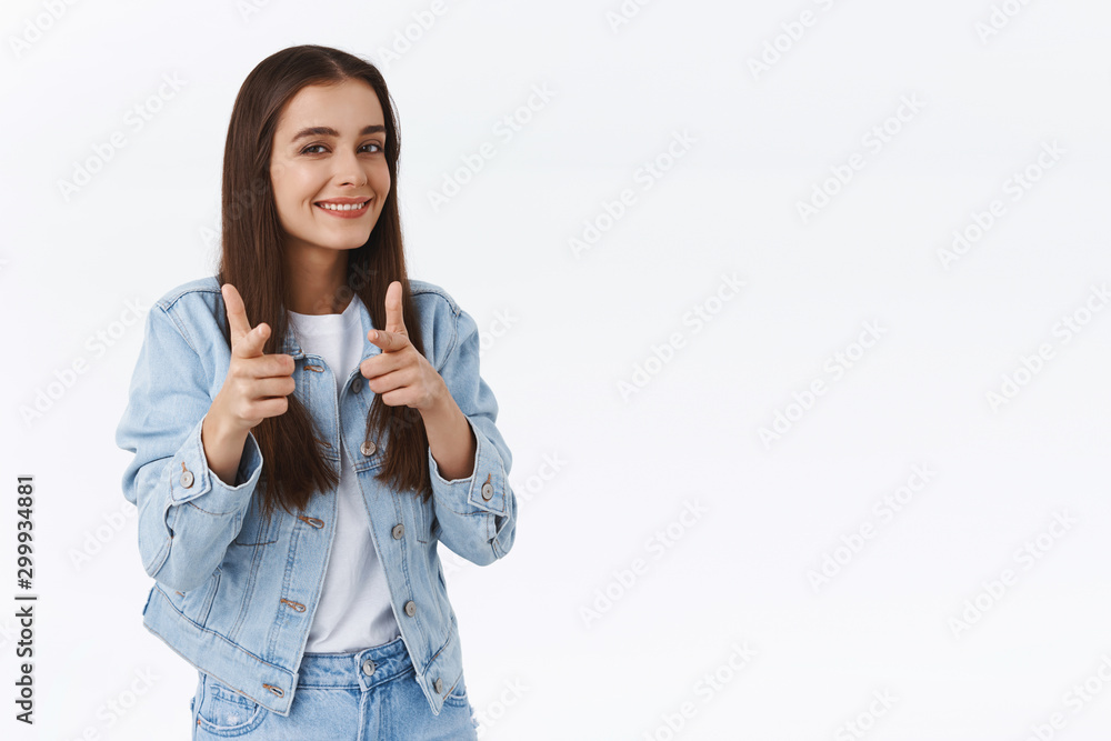 Cheeky sly good-looking brunette woman in denim jacket, pointing finger pistols at camera and smiling as hinting something, encourage friend visit store or buy gifts for upcoming holidays Cheeky sly good-looking brunette woman in denim jacket, pointing finger pistols at camera and smiling as hinting something, encourage friend visit store or buy gifts for upcoming holidays