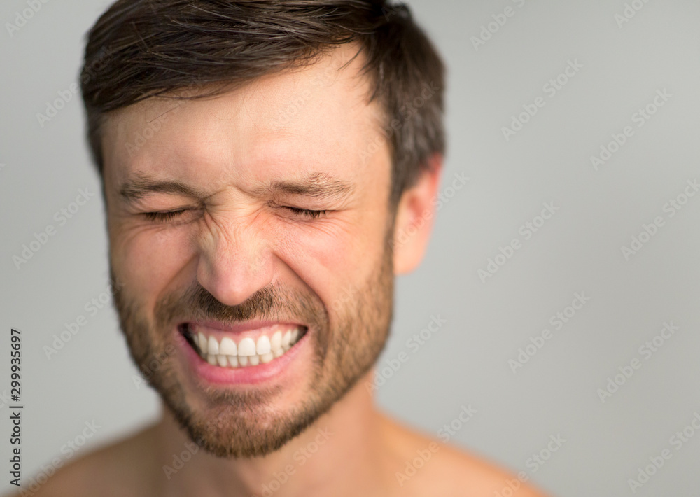 Man With Closed Eyes Smiling Posing Over Gray Studio Background Man With Closed Eyes Smiling Posing Over Gray Studio Background