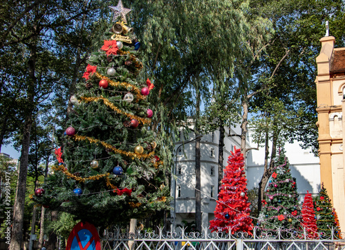 The festive decoration of a Christmas tree on fence of The Church of St. Joan of Arc at Ho Chi Minh city, Vietnam.