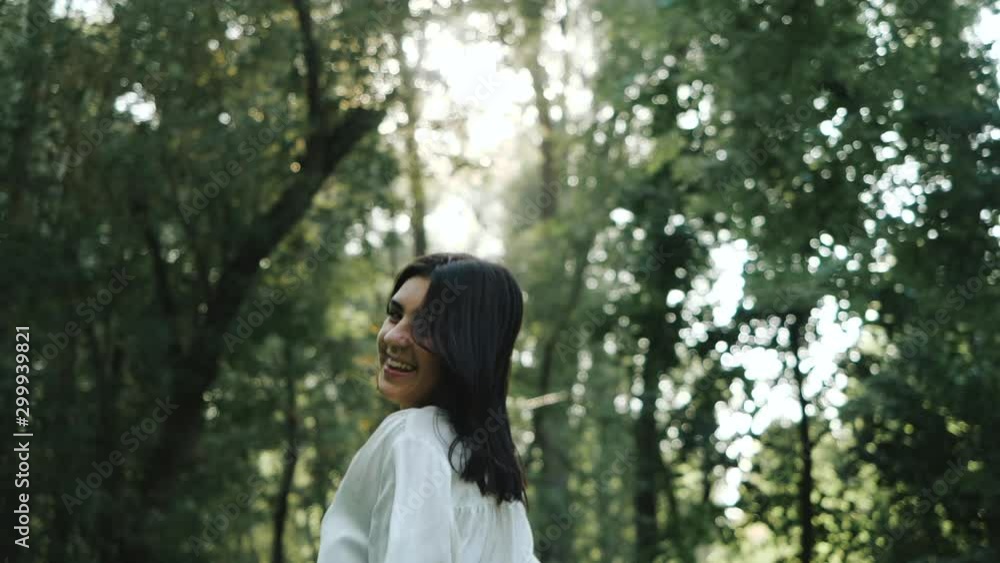 Close up portrait of smiling and joyful feminine girl with Silky hair blowing in the wind. Woman runs, turns around and Looks to camera in Slow motion. Female natural beauty. Close up portrait of smiling and joyful feminine girl with Silky hair blowing in the wind. Woman runs, turns around and Looks to camera in Slow motion. Female natural beauty.