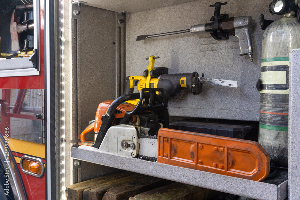 Fire truck compartment with chainsaw and other tools. Fire truck compartment with chainsaw and other tools.
