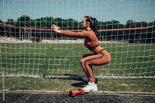 Portrait of One Sports Fitness Girl Dressed Fashion Sportswear Outfit Doing Exercise with Dumbbell and Training at the City Stadium, Healthy Lifestyle Concept