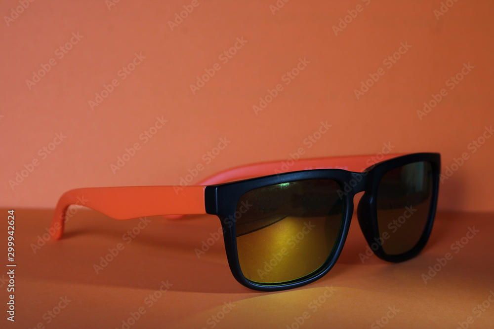 Orange sunglasses on an orange background. Orange sunglasses on an orange background.