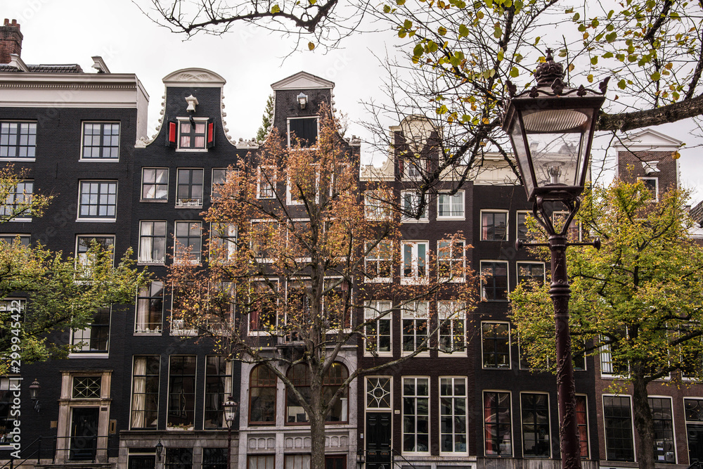 Amsterdam typical dutch houses. Netherlands autumn cityscape.